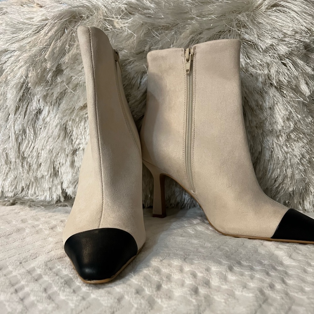 Cream with black toe cap ankle boots.